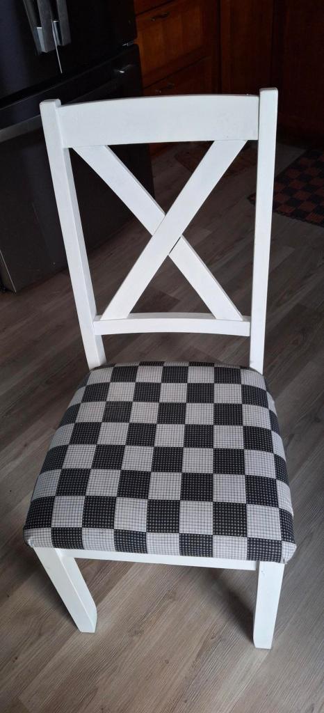 kitchen chair with white paint and black and white checked seat.