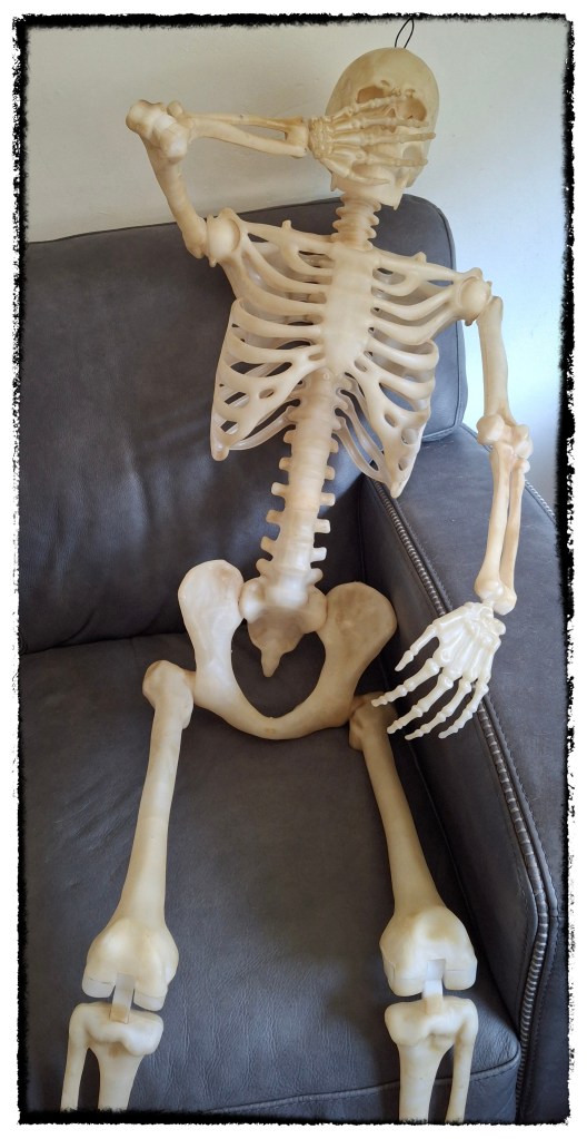 Exhausted skeleton on a couch