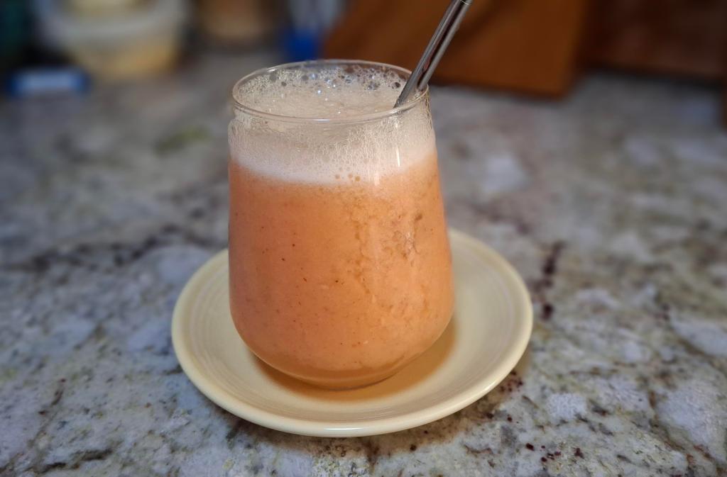 glass with straw filled with fruit drink