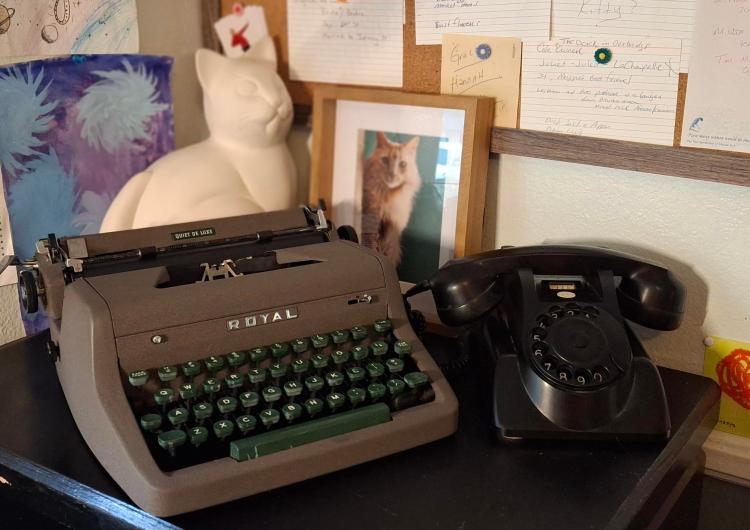 1950 typewriter, 1940 Art Deco phone and Italian cat sculpture on a desk